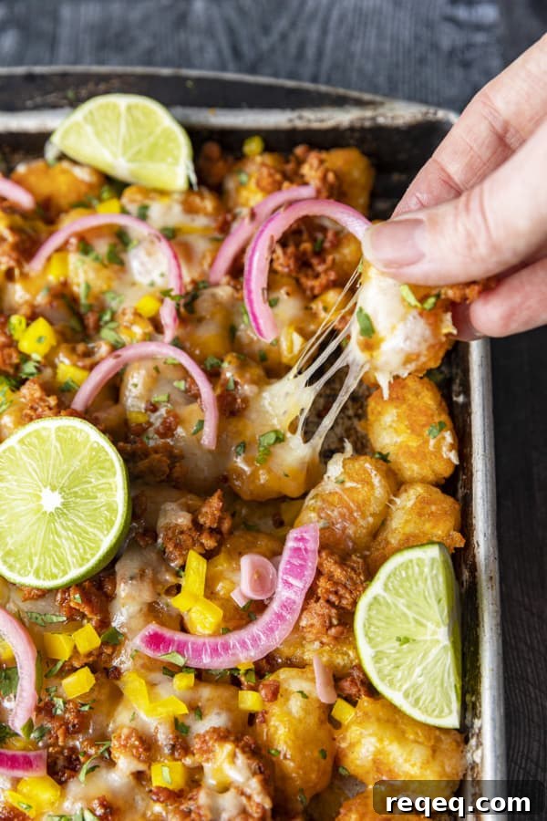 Change up Nacho Night by serving Tater Tot Nachos a.k.a. Totchos with Chorizo, Cheddar, green onions, and other nacho goodies!