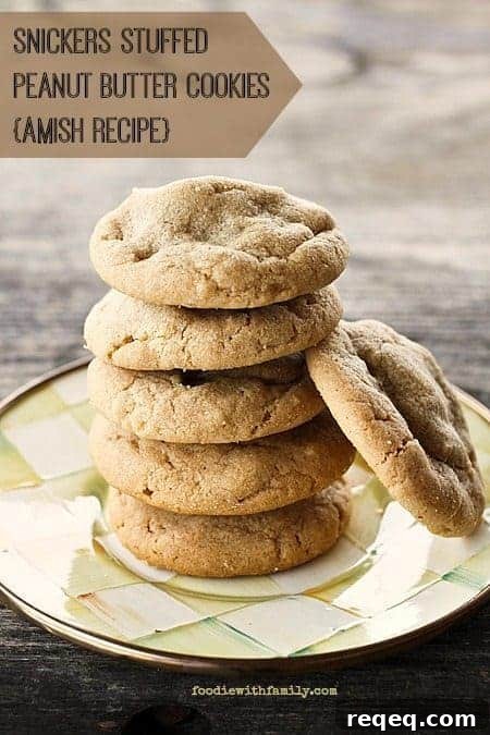 Snickers-Stuffed Peanut Butter Cookies — Amish Recipe 2 Amish recipe Snickers Stuffed Peanut Butter Cookies #cookies foodiewithfamily.com