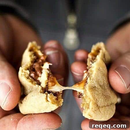 Gooey, Snickers Stuffed Peanut Butter Cookies #cookies foodiewithfamily.com