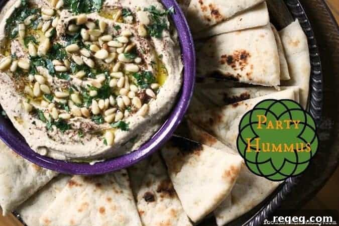 Crowd-Pleasing Party Hummus Recipe for Entertaining 3 Party Hummus served warm with toppings.