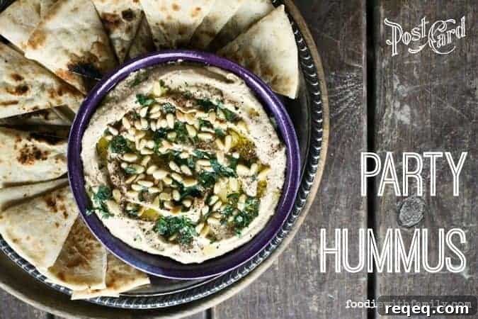 Crowd-Pleasing Party Hummus Recipe for Entertaining 4 Party Hummus with olive oil, za'atar, pine nuts, and parsley.