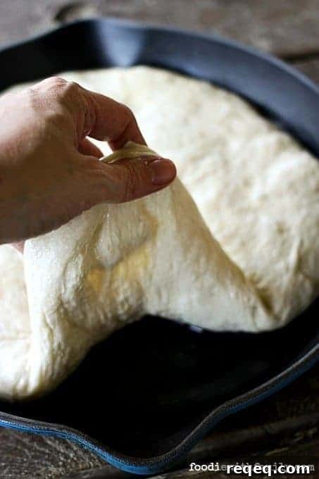 Pan Pizza Guide: How It’s Made, Why It Works, and Topping Ideas 3 Preparing dough for The Best Pan Pizza {super easy!} from foodiewithfamily.com