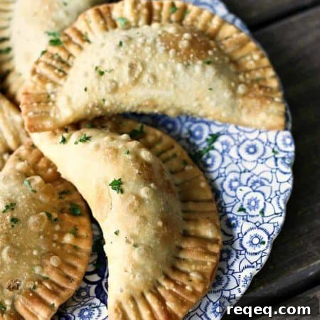 Shepherd's Pie Empanadas {beef, gravy, corn, peas, and mashed potato stuffed in a flaky, golden brown crust}