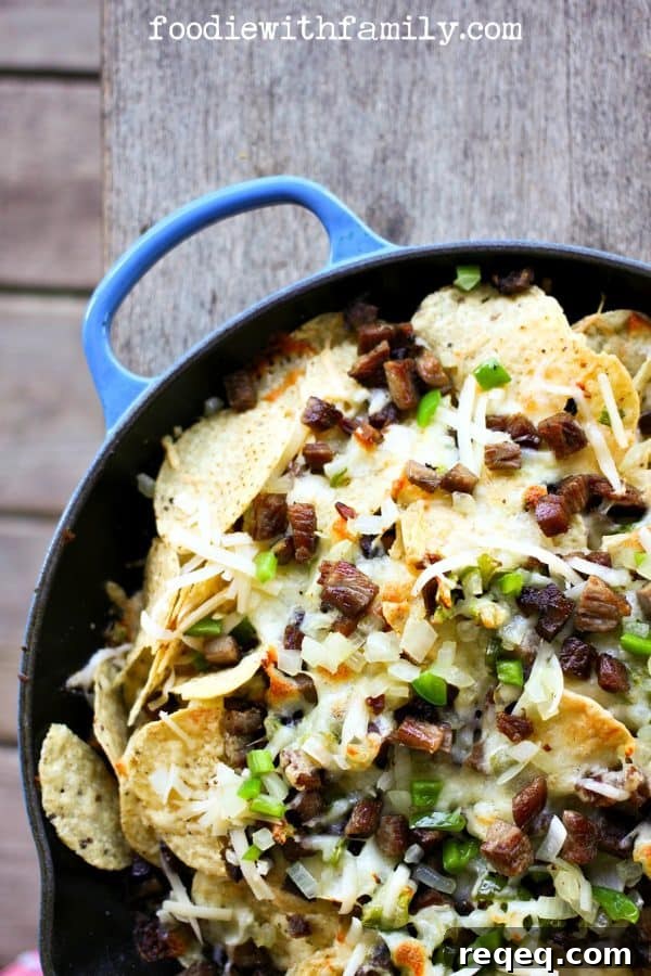 Cheesesteak Nachos are comfort food deluxe from foodiewithfamily.com beef, cheese, onions, peppers