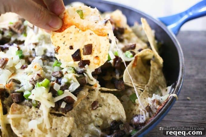 Beef, cheese, onions, peppers, and chips, Cheesesteak Nachos are comfort food deluxe from foodiewithfamily.com