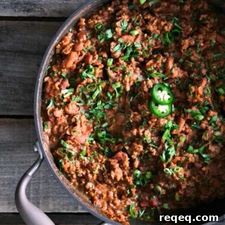 Tex Mex Mash: smashed pinto beans, seasoned browned ground beef, and crispy bacon simmered in a garlicky, chipotle tomato sauce from foodiewithfamily.com