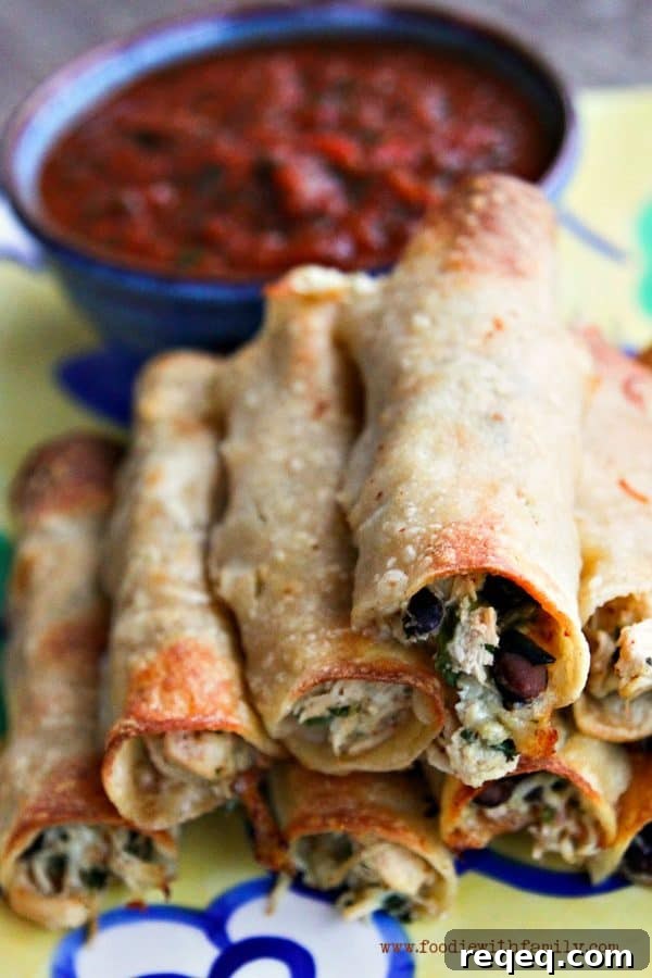 Cheesy Baked Chicken and Bean Taquitos Recipe 2 Baked Cheesy Chicken and Bean Taquitos from foodiewithfamily.com