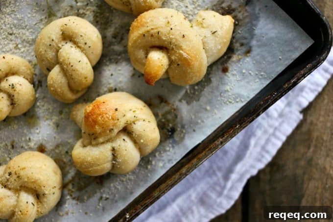 Homemade Garlic Knots Recipe – Soft, Buttery, Oven-Baked 3 Easy Garlic Knots on the pan from foodiewithfamily.com