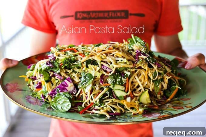 Asian Noodle Salad with Sesame Ginger Dressing 4 Asian noodle Salad with a garlic soy vinaigrette and loads of colourful, fresh vegetables on a Mackenzie Childs Platter held by a muscular teen boy.