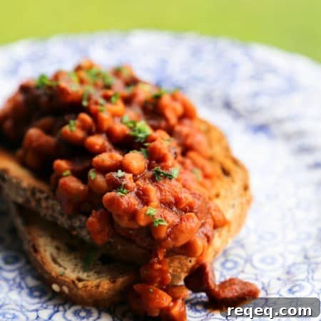 Maple and coffee flavoured Slow-Cooker Breakfast Baked Beans full of Canadian Bacon and breakfast sausage from foodiewithfamily.com