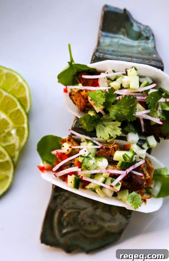 Crispy Jicama Tacos with Fresh Lime & Avocado crema 2 Jicama Tacos with carnitas, cucumber onion salsa, radishes, and cilantro.