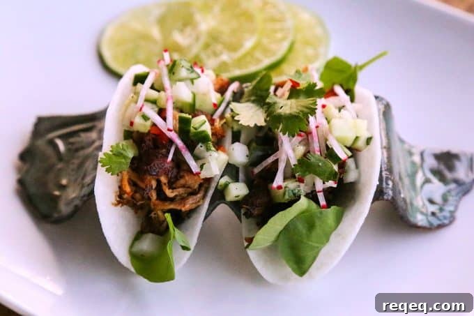 Crispy Jicama Tacos with Fresh Lime & Avocado crema 3 Jicama Tacos with carnitas, cucumber onion salsa, radishes, and cilantro.