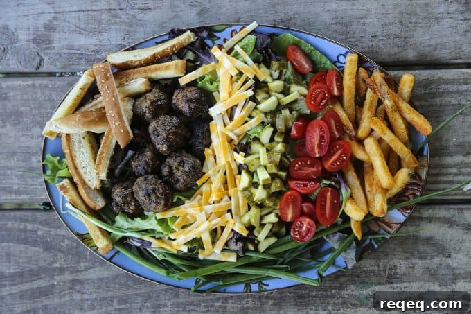 Cheeseburger Salad Recipe: Classic Burger Flavors in a Bowl 4 Cheeseburger Salad with sesame bun croutons, grilled meatballs, green onions, cheese, pickles, tomatoes, and fries.