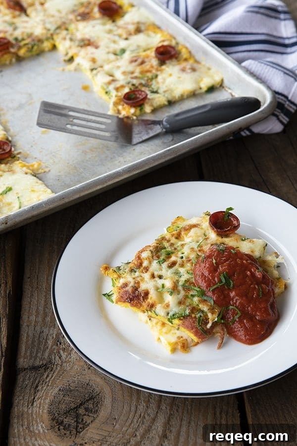 Pizza Frittata: delicious slices baked egg with spicy pepperoni, flavourful green onions and fresh parsley, and melted mozzarella cheese throughout. We don't stop there, though! We also top it with more grated mozzarella and pepperoni and give it a quick run under the broiler to melt the cheese and crisp up the pepperoni, then serve it with marinara or pizza sauce.