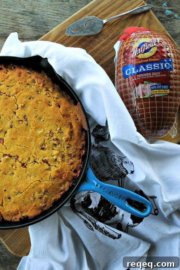 Toasty Ham Cheddar Onion Cornbread is buttermilk cornbread bursting with golden brown ham cubes, caramelized onions, and pockets of melted Cheddar cheese.