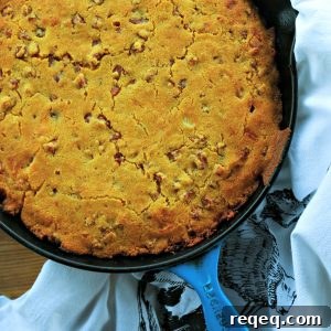 Toasty Ham Cheddar Onion Cornbread is buttermilk cornbread bursting with golden brown ham cubes, caramelized onions, and pockets of melted Cheddar cheese.
