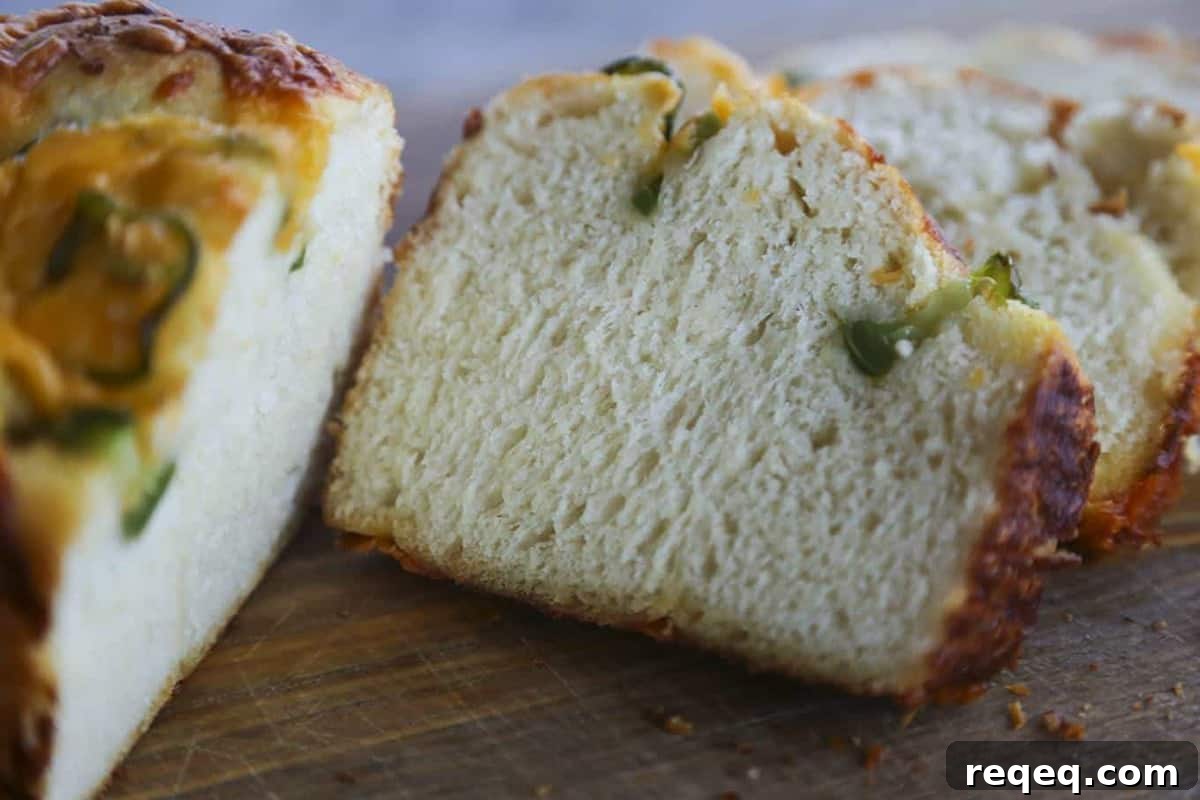Jalapeno Cheddar Bread: tender sandwich bread studded with fresh jalapeno slices and lovely melted cheddar cheese with a thick cap of toasted cheddar on top. Just like Wegman's bakery bread!