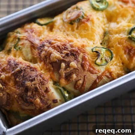 Jalapeno Cheddar Bread: tender sandwich bread studded with fresh jalapeno slices and lovely melted cheddar cheese with a thick cap of toasted cheddar on top. Just like Wegman's bakery bread!
