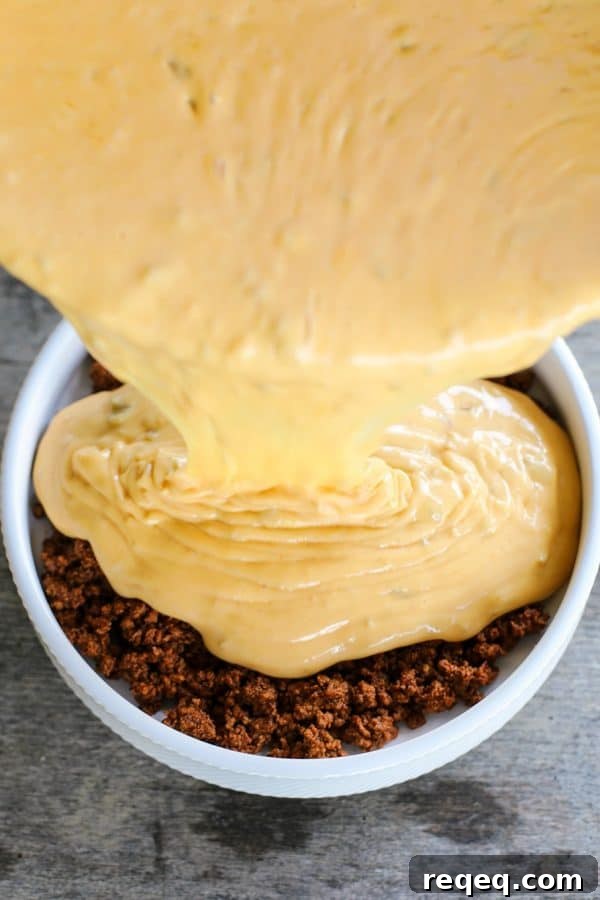 Spicy Chili con Queso Dip Recipe for Parties and Game Day 4 Ooey-gooey, chile studded heavenly queso smothers your favourite chili for a bowl of the ultimate Chili Con Queso Dip. Get those chips ready to go!