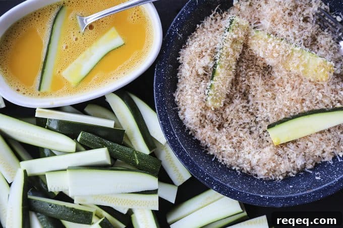 Crispy Parmesan Zucchini Fries Baked to Golden Perfection 3 Golden baked zucchini fries with crispy parmesan coating.