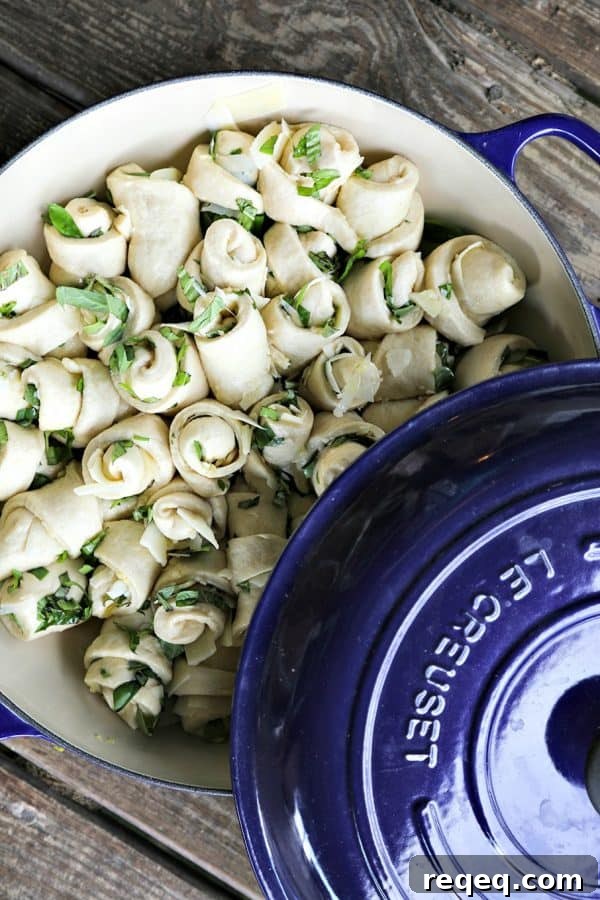 Garlic Basil Parmesan Rolls are my idea of a perfect bread. Perfect bread dough brushed with garlic infused olive oil and rolled around chopped garlic, fresh basil, and flakes of creamy, nutty Parmesan cheese then baked up to a beautiful, golden brown, tender-yet-chewy work of art.