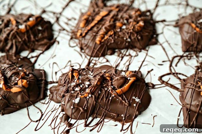 Chocolate Covered Caramel Stuffed Pretzels; crunchy sourdough pretzels enrobed in dark chocolate with a sprinkling of flaky sea salt that ooze perfectly gooey caramel when you bite into them.