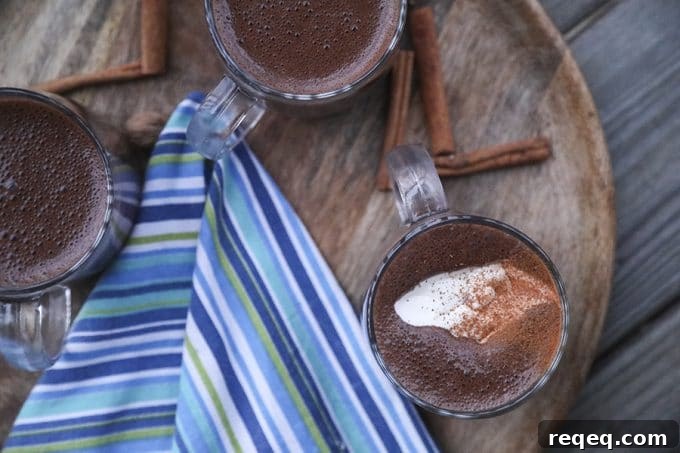 Creamy, rich, blender made spiced hot chocolate is made with just two main ingredients: good chocolate and milk. It has just a hint of warming cinnamon, nutmeg, and cayenne and is as easy as the powdered packets but worlds better.