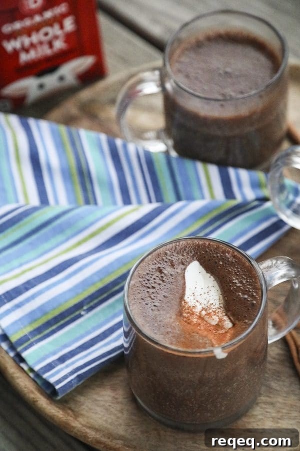 Creamy, rich, blender made spiced hot chocolate is made with just two main ingredients: good chocolate and milk. It has just a hint of warming cinnamon, nutmeg, and cayenne and is as easy as the powdered packets but worlds better.