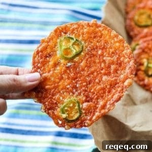 Round, crispy cheese crackers, fricos, 2-ingredient jalapeno popper crisps in paper bag, blue white and green tea towel