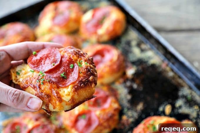 Pepperoni Bialys Recipe: Savory Pizza-Style Baked Rolls 2 Pepperoni Pizza Bialys: fresh-from-the-oven, chewy, bagel-like bread topped with chopped garlic, a hint of pizza sauce and olive oil, melted cheese, and crisp pepperoni.