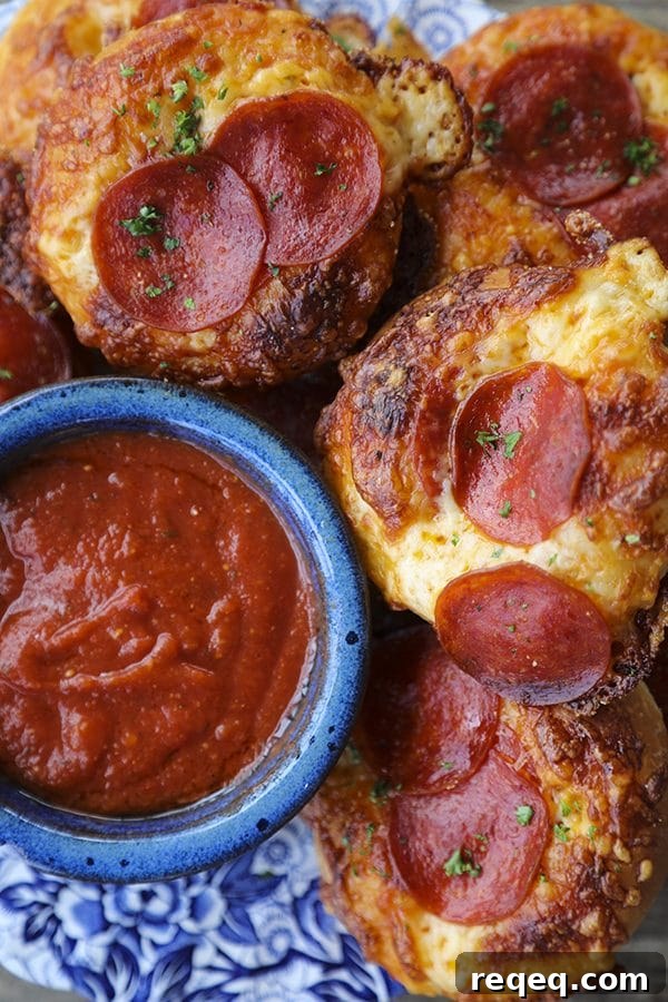 Pepperoni Bialys Recipe: Savory Pizza-Style Baked Rolls 4 Pepperoni Pizza Bialys: fresh-from-the-oven, chewy, bagel-like bread topped with chopped garlic, a hint of pizza sauce and olive oil, melted cheese, and crisp pepperoni.