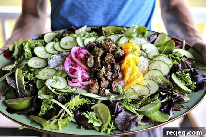Vietnamese Shaking Beef (Bo Luc Lac): Classic Sizzling Steak Recipe 2 Bo Luc Lac - Shaking Beef - Vietnamese salad with mango, vermicelli, and black pepper lime dressing.