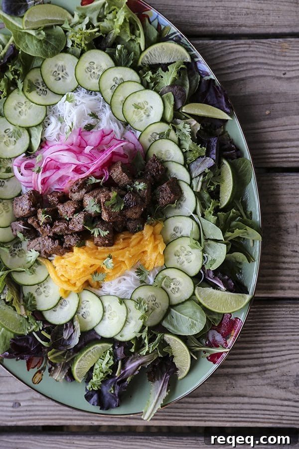 Vietnamese Shaking Beef (Bo Luc Lac): Classic Sizzling Steak Recipe 3 Bo Luc Lac - Shaking Beef - Vietnamese salad with mango and vermicelli.