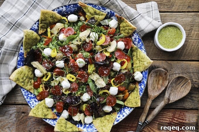 Pizza Salad Recipe: How to Make a Crispy Crust Pizza Salad Bowl 2 Supreme Pizza Salad: Mixed greens with crisped pepperoni, pesto pita chips, artichoke hearts, mini mozzarella balls, marinated olives, cherry tomatoes, sun dried tomatoes, pepperoncini and pesto vinaigrette.
