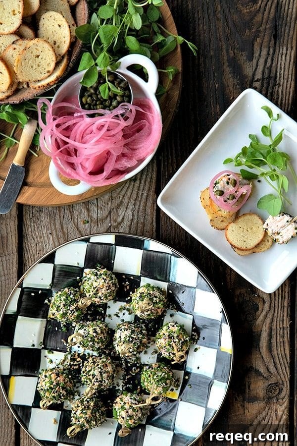 These gorgeous little two-bite, miniature cheese balls are dressed up with smoked salmon, chives, and everything bagel seasoning and taste like New York City when served with bagel chips, pickled red onions, and capers.