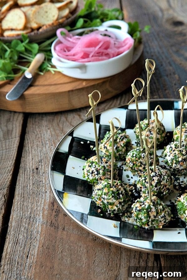 These gorgeous little two-bite, miniature cheese balls are dressed up with smoked salmon, chives, and everything bagel seasoning and taste like New York City when served with bagel chips, pickled red onions, and capers.
