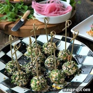 These gorgeous little two-bite, miniature cheese balls are dressed up with smoked salmon, chives, and everything bagel seasoning and taste like New York City when served with bagel chips, pickled red onions, and capers.