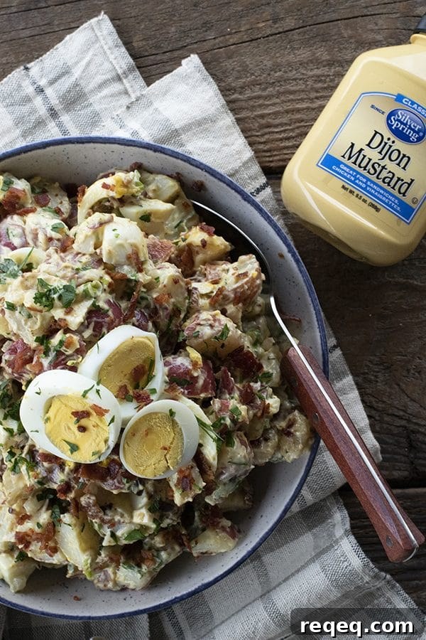 This next level potato salad has a full pound of crispy bacon, a creamy dressing with a hint of Dijon mustard, fresh herbs, hard boiled eggs, and tender potatoes. It's sure to be your new favourite potato salad for grilling and picnic season.