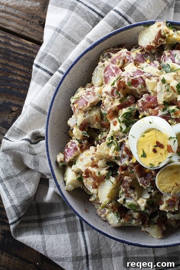 This next level potato salad has a full pound of crispy bacon, a creamy dressing with a hint of Dijon mustard, fresh herbs, hard boiled eggs, and tender potatoes. It's sure to be your new favourite potato salad for grilling and picnic season.