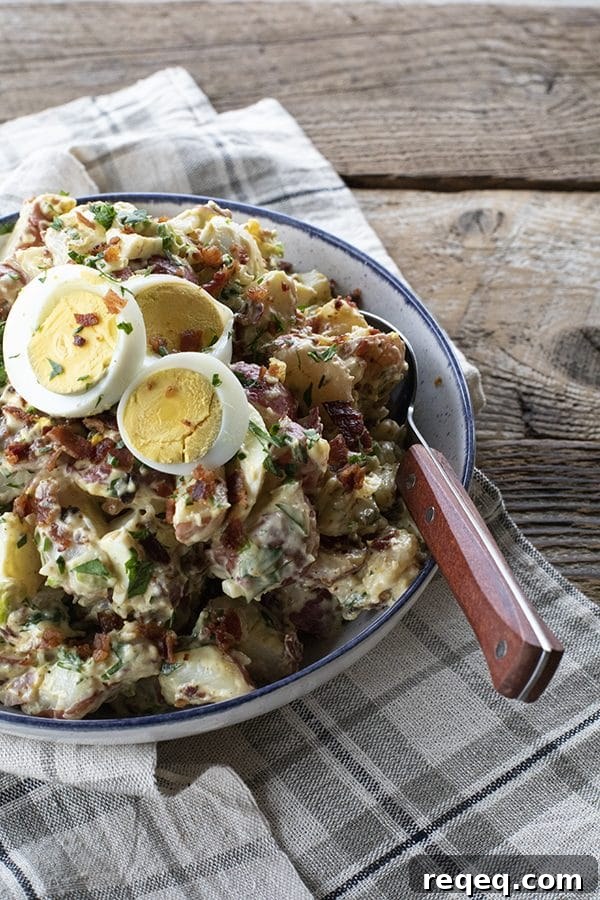 This next level potato salad has a full pound of crispy bacon, a creamy dressing with a hint of Dijon mustard, fresh herbs, hard boiled eggs, and tender potatoes. It's sure to be your new favourite potato salad for grilling and picnic season.