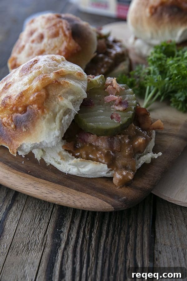 Classic Homemade Sloppy Joes Recipe for Juicy Sandwiches 4 rich tomato gravy with melted Cabot cheese and crispy chopped bacon on a toasted bun with dill pickles