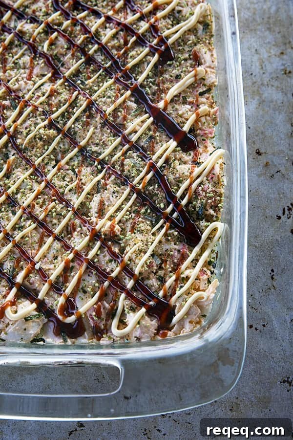 California Roll Sushi Bake Recipe: Creamy Baked Sushi Casserole 7 Sushi Bake ready to go into the oven with sauce.