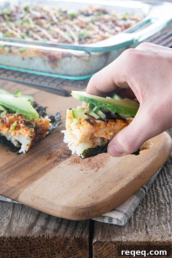 California Roll Sushi Bake Recipe: Creamy Baked Sushi Casserole 8 sushi bake on nori with cucumbers and avocado being lifted
