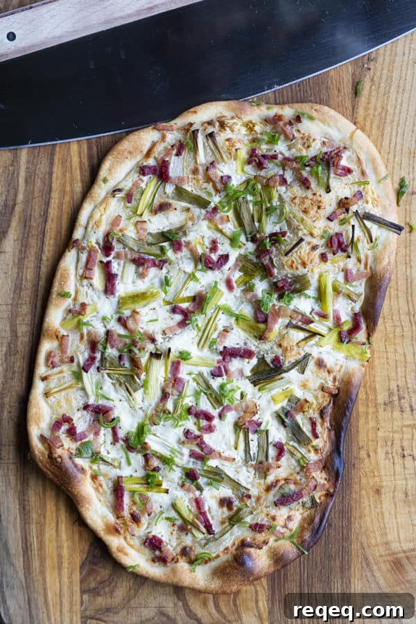 Flammekueche, tarte Flambée, or flammkuchen is a fast and easy bacon and onion pizza type flatbread made with crème fraîche or sour cream. No yeast needed!