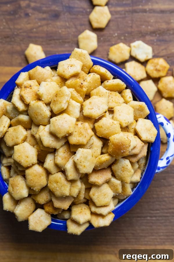 Old Bay Seasoned Oyster Crackers in a blue and white bowl with a canister of Old Bay Seasoning.