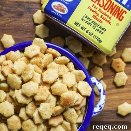 Old Bay Seasoned Oyster Crackers in a blue and white bowl with a canister of Old Bay Seasoning.