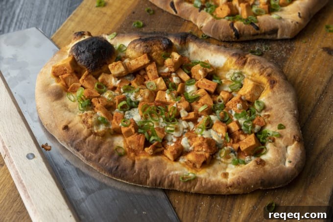 Tender cubes of Spicy Buffalo chicken, blue cheese crumbles or another cheese of your choice, thinly sliced green onions, and a drizzle of blue cheese dressing or ranch dressing top flatbread proving that great food doesn't have to be complicated! Buffalo Chicken Flatbread is equally fabulous as a great appetizer for game day or as an easy dinner.