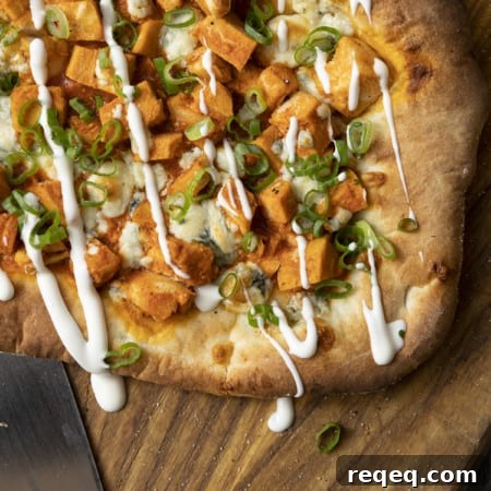 Tender cubes of Spicy Buffalo chicken, blue cheese crumbles or another cheese of your choice, thinly sliced green onions, and a drizzle of blue cheese dressing or ranch dressing top flatbread proving that great food doesn't have to be complicated! Buffalo Chicken Flatbread is equally fabulous as a great appetizer for game day or as an easy dinner.