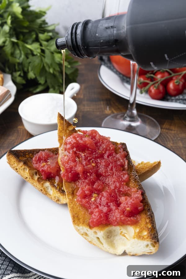 Spanish Tomato Toast: Classic Pan con Tomate Recipe for Brunch 4 Close-up of pan con tomate topped with olive oil and flaky salt.