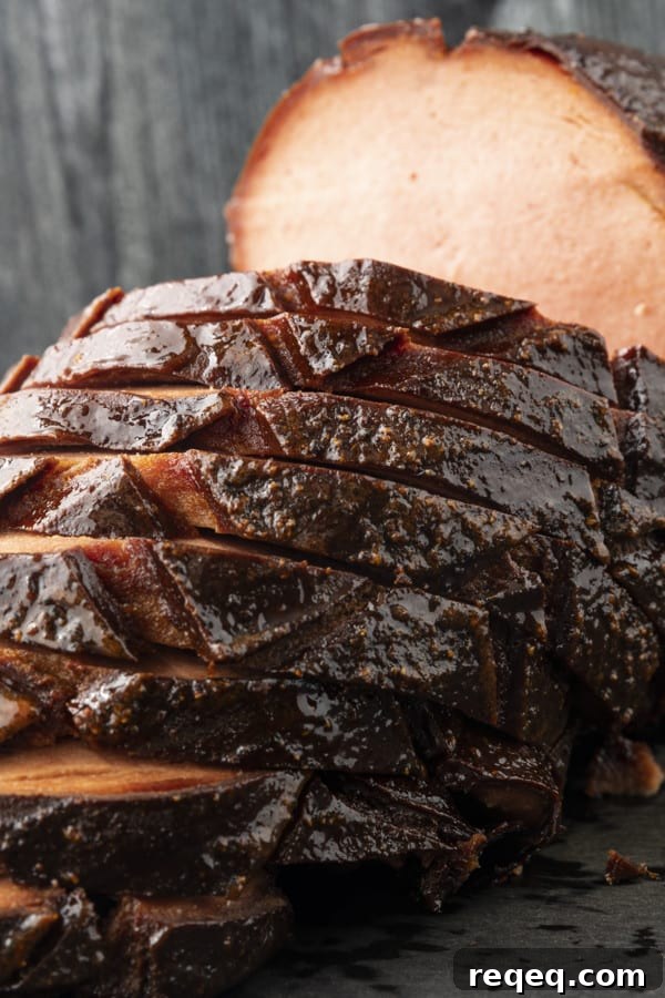 How to Smoke Bologna for Big Flavor at Home 2 crispy-edged bologna on a hamburger bun or great homemade sandwich bread with mustard or mayo, lettuce, tomato, and a slab of sweet onion.